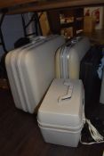 A selection of hard bodied travel cases including Delsey and Samsonite