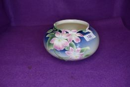 A squat Franz vase having blue tones to ground and pink Orchid type pattern.