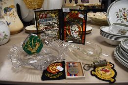 A selection of curios including military badges and animal horn whistle