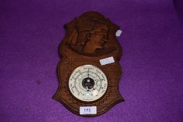 An oak carved barometer with a German design