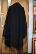 An antique Victorian black shawl with extensive and intricate beading, embroidery and deep fringe to