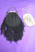 Two antique evening bags, both with carved clasp fastenings, one having extensive fringing and the