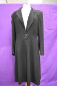 A 1940s ladies black wool crepe Malbeck coat having pleated details to back and single button