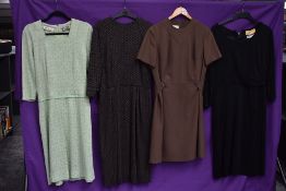 A collection of vintage dresses, predominantly 1960s, various sizes and styles.