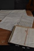 A small collection of linens including unused embroidered pillow cases and more.