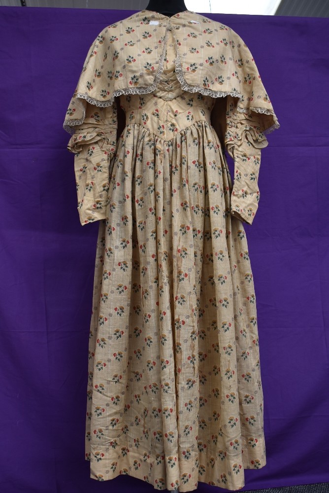 A Victorian cotton dress and lace edged cape having floral print on beige ground, superb details