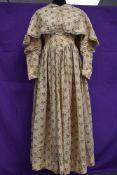 A Victorian cotton dress and lace edged cape having floral print on beige ground, superb details