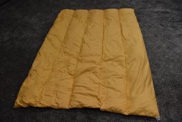 A plump vintage mustard yellow eiderdown.