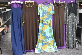 A mixture of vintage dresses,60s-70s, including bright patterned maxi dress.