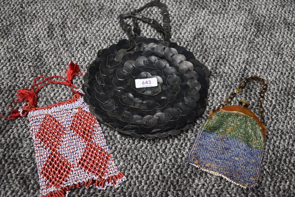 A trio of vintage and antique handbags including circular leather bag in black and two smaller