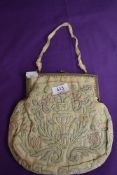 An antique framed evening bag having clasp fastening and quilted pastel pattern to front and reverse