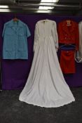 A mixture of ladies vintage clothing including wedding dress.