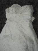 A good quality strapless wedding dress having extensive embroidery and beading with lace up back,