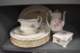 A collection of mid century plates,coffee pot and more having rose transfer pattern.