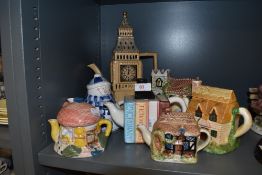 An array of novelty tea pots including cottages and more.