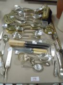 A selection of cutlery and flatware including bone handle butter knife