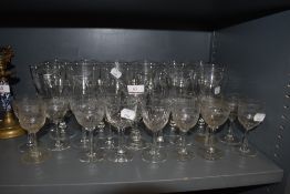 A large collection of glasses including etched examples having Greek key design.