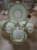 A part tea service by Grafton having gilt and green decoration