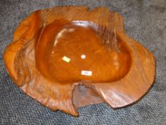 A large ethnic wood bowl having naturalist design driftwood and carved centre approx 45cm across