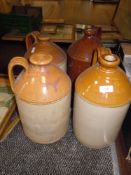 Four salt glazed beer or similar flagons or jugs