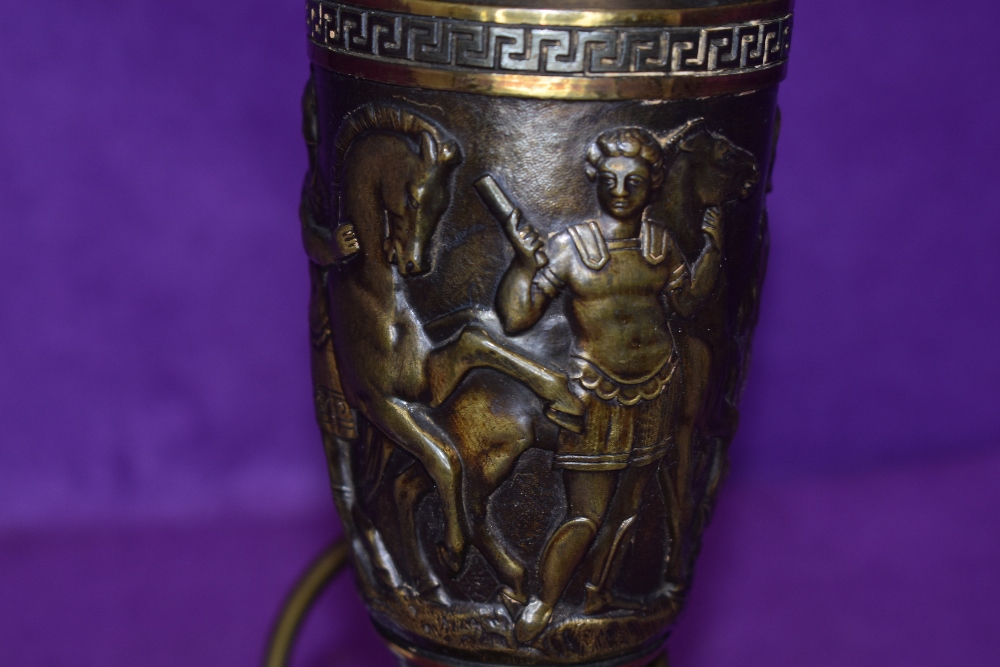 A weighty metal lamp base having Greek scene with horses and key design. - Image 2 of 2