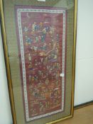 A intricate oriental embroidery on silk, framed and glazed.