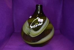 A large mottled green art glass vase.