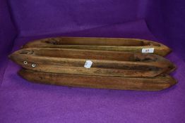 Five large wooden antique shuttles/bobbins.