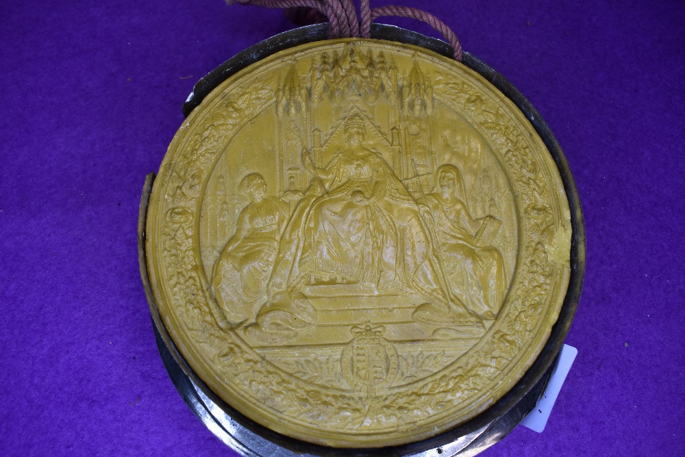 An unusual large antique wax seal or similar.