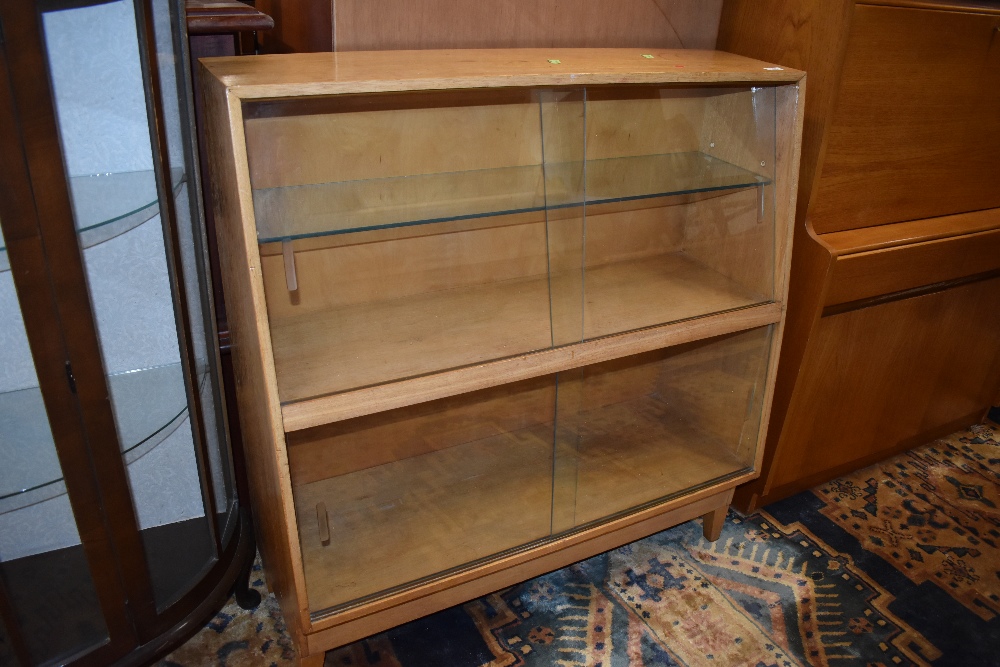 A mid 20th Century golden oak bookcase having glazed sloped front, width approx. 91cm