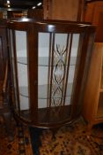 A mid 20th Century stained frame demi lune display cabinet
