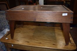 An early 20th Century craftsman made oak bed style table, having exposed joints and carry handles