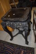 A 19th Century Chinese carved hardwood side table, having predominantly vine decoration, height