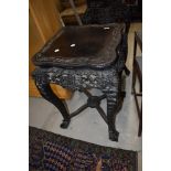 A 19th Century Chinese carved hardwood side table, having predominantly vine decoration, height