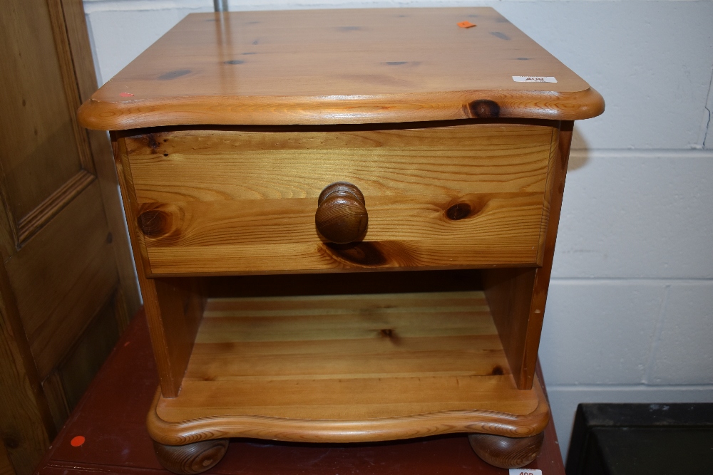 A modern pine bedside table with drawer