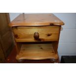 A modern pine bedside table with drawer