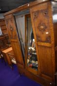 An early 20th Century oak mirror door wardrobe