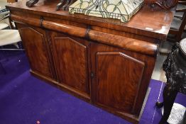 A Victorian mahogany sideboard, having ledge back, three frieze drawers, and triple cupboard