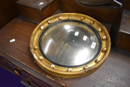 A gilt plaster wall mirror, of circular form, diameter approx. 39cm