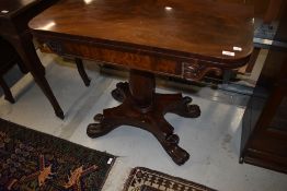 A William IV flame mahogany fold over tea table