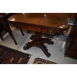 A William IV flame mahogany fold over tea table