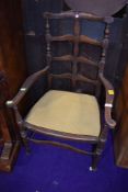 A late 19th or early 20th Century carver chair having turned and shaped frame and drop in