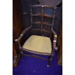 A late 19th or early 20th Century carver chair having turned and shaped frame and drop in