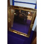 A modern gilt framed wall mirror, approx. 75 x 65cm