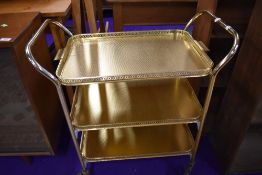 A vintage brass tea trolley