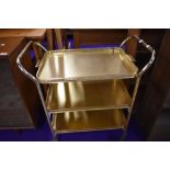 A vintage brass tea trolley