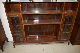 An early 20th Century mahogany bookcase, with narrow glazed display sections to each side, width