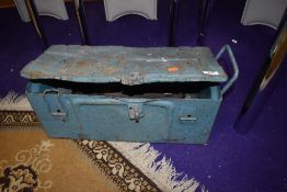 A vintage metal toolbox and contents