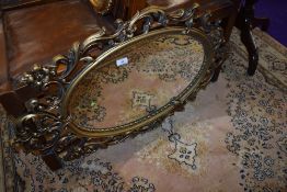 A gilt effect plastic wall mirror