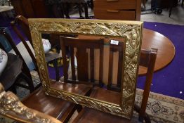 A modern gilt effect wall mirror, having vine decoration